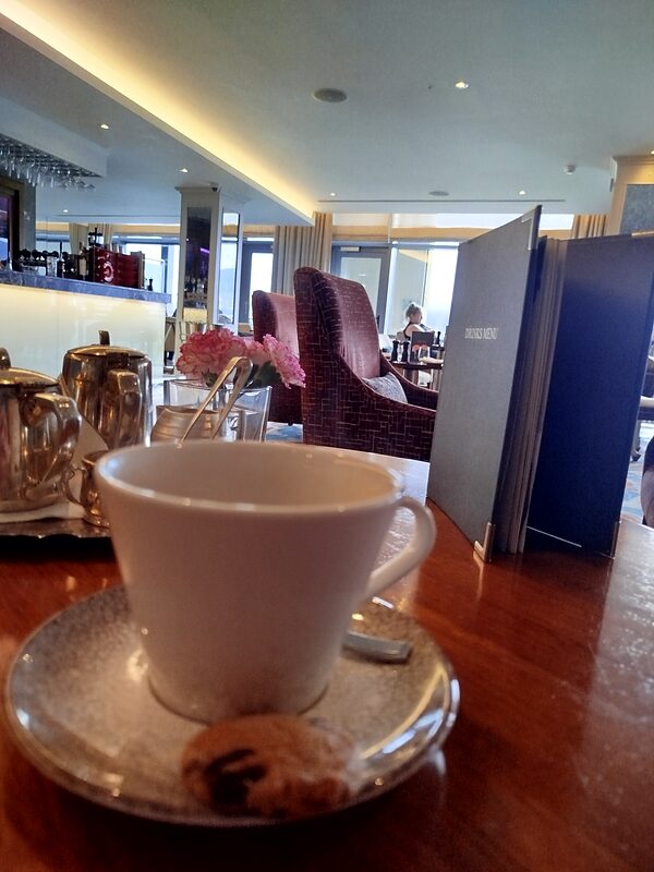 A cup of tea on a table by the window of a hotel lounge above the lakes at Aghadoe Heights, Killarney